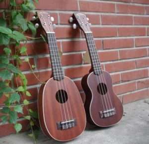 Ukulele in the shape of a pineapple and a guitar